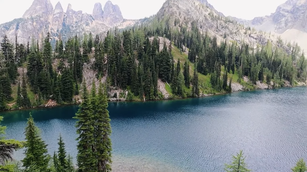 blue lake and hills covered with trees