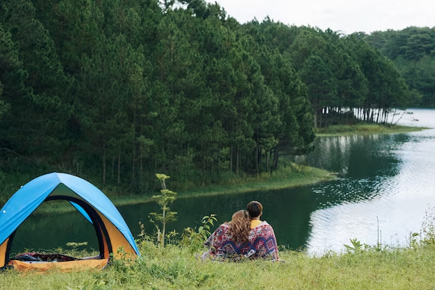 A guy and a girl sitting near a tent